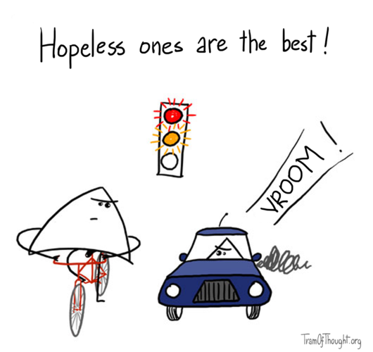 Traffic light shows red and orange (changing to green) - one Triangle-person is getting ready to go on their bike, next to another Triangle-person in a car. They look at each other posing a challenge, and the caption says: Hopeless ones are the best!